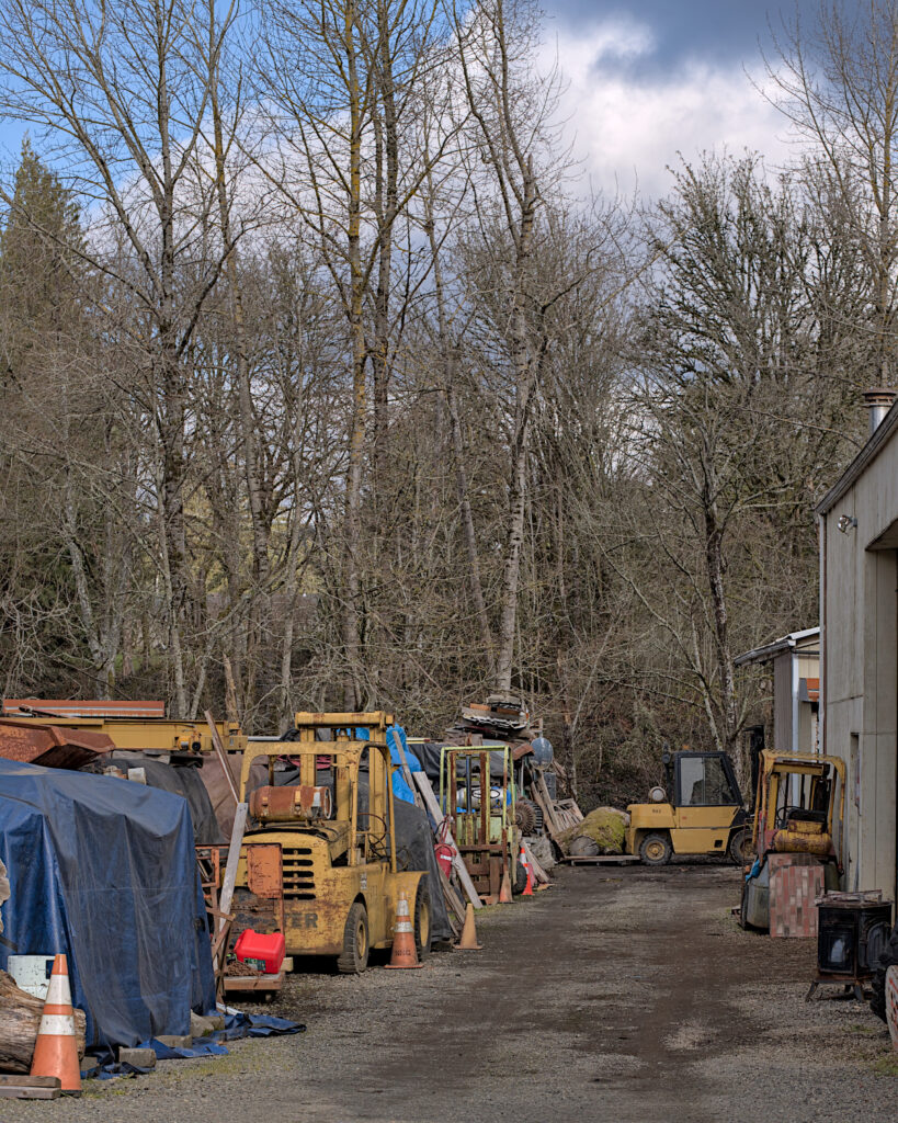 Bob’s Big Boards backyard sawmill in Longview, Washington, producing custom lumber and handcrafted wood slabs with local timber, artisanal milling equipment, and Pacific Northwest craftsmanship in a rural workshop setting.