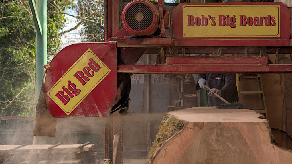 Bob’s Big Boards backyard sawmill in Longview, Washington, producing custom lumber and handcrafted wood slabs with local timber, artisanal milling equipment, and Pacific Northwest craftsmanship in a rural workshop setting.