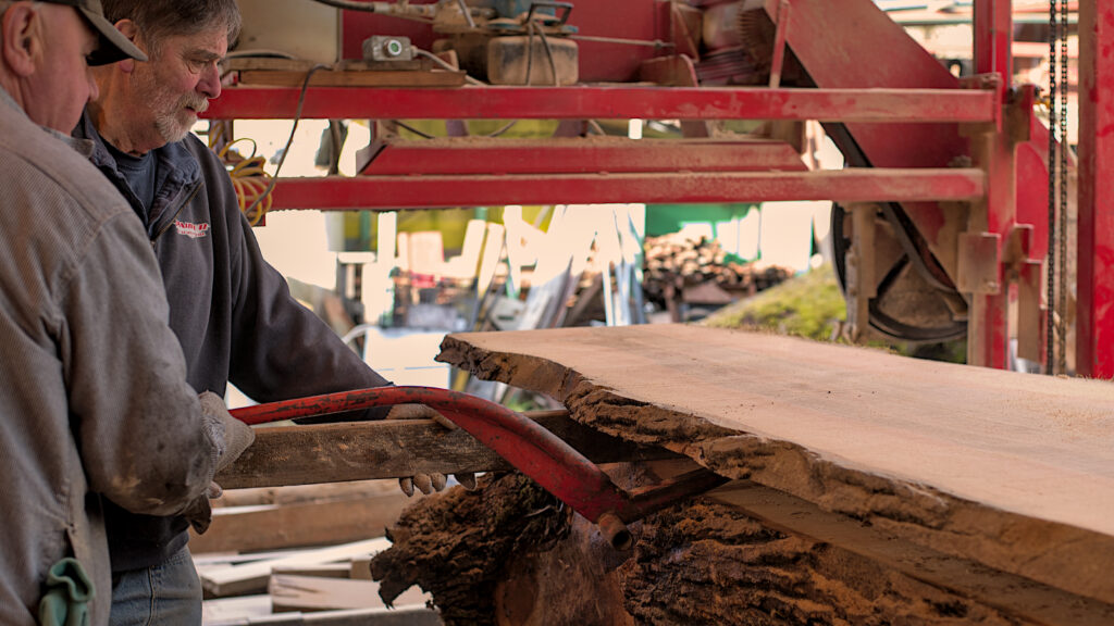 Bob’s Big Boards backyard sawmill in Longview, Washington, producing custom lumber and handcrafted wood slabs with local timber, artisanal milling equipment, and Pacific Northwest craftsmanship in a rural workshop setting.