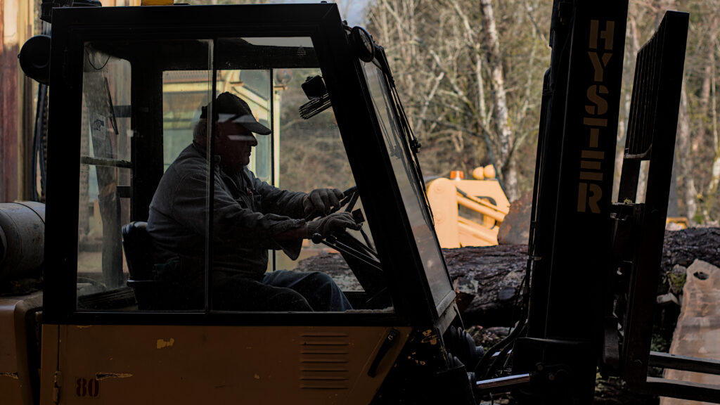 Bob’s Big Boards backyard sawmill in Longview, Washington, producing custom lumber and handcrafted wood slabs with local timber, artisanal milling equipment, and Pacific Northwest craftsmanship in a rural workshop setting.