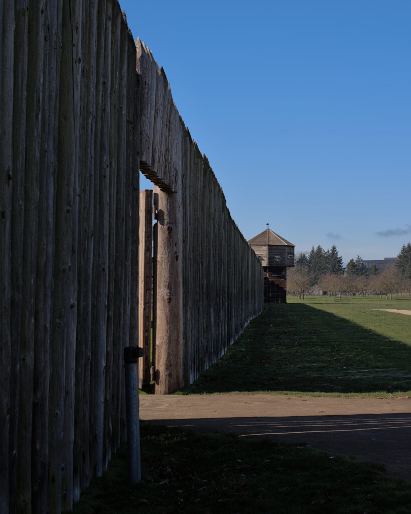 Historical reenactors in period costumes at Fort Vancouver National Historic Site in Vancouver, Washington, depicting 19th century fur trade era with restored buildings, museum displays, and living history exhibits.