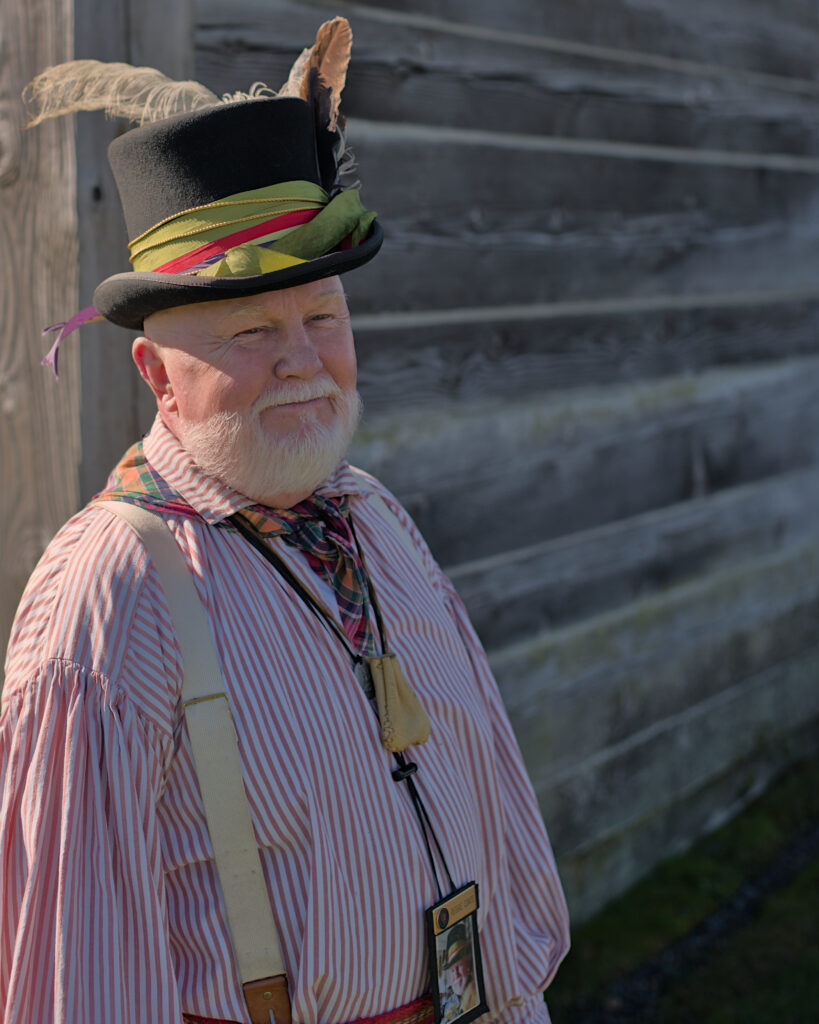 Historical reenactors in period costumes at Fort Vancouver National Historic Site in Vancouver, Washington, depicting 19th century fur trade era with restored buildings, museum displays, and living history exhibits.
