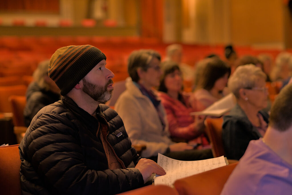 LaRhonda Steele performing live soul, blues, and jazz music on stage at the historic Columbia Theatre in Longview, Washington, during the venue’s centennial celebration with band and community choir.