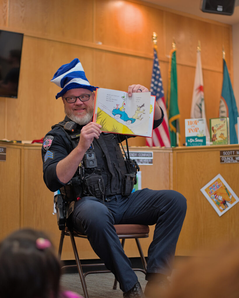Kalama Police Department officers interacting with the community, including conducting traffic stops, giving preschool children a tour of the station, and participating in National Night Out events in Southwest Washington.