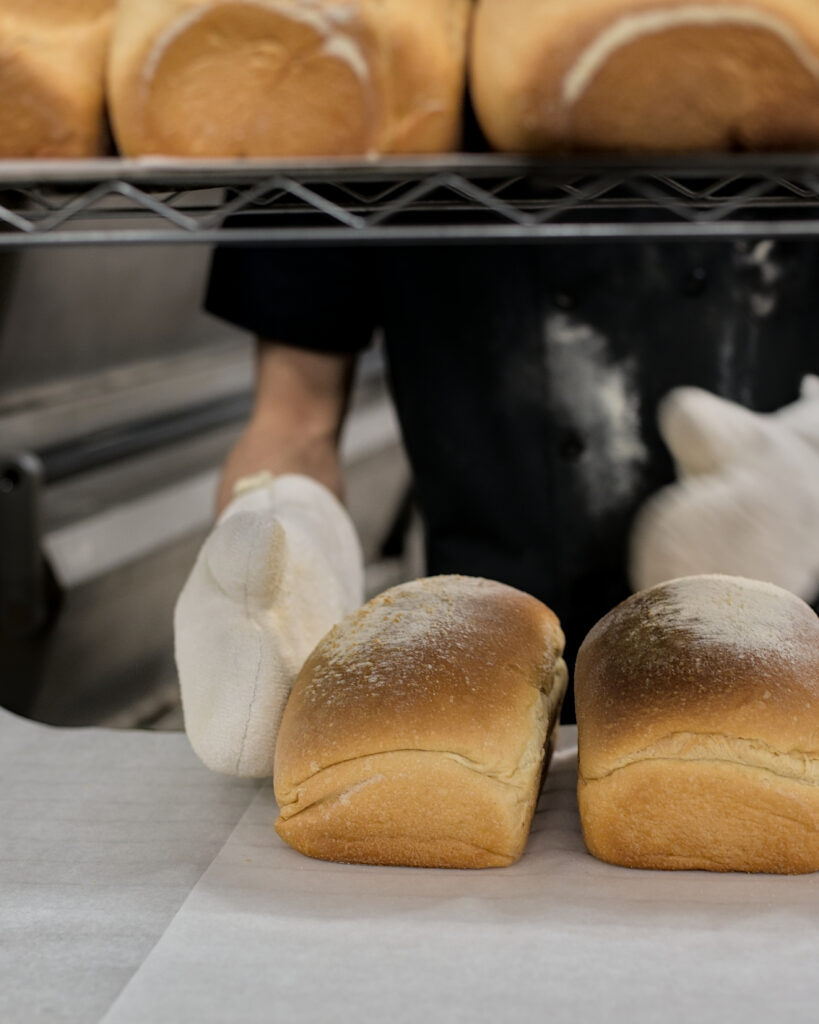 Artisan bakery in Kalama, Washington, featuring freshly baked sourdough bread, wheat loaves, buns, and pizza dough made with a local starter and baked in a traditional oven in the Lower Columbia region.